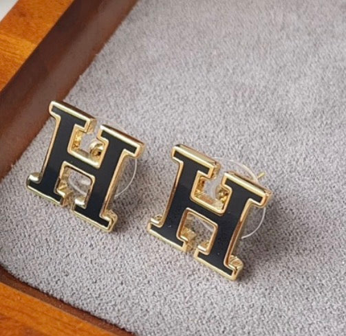 gold and black H earrings
